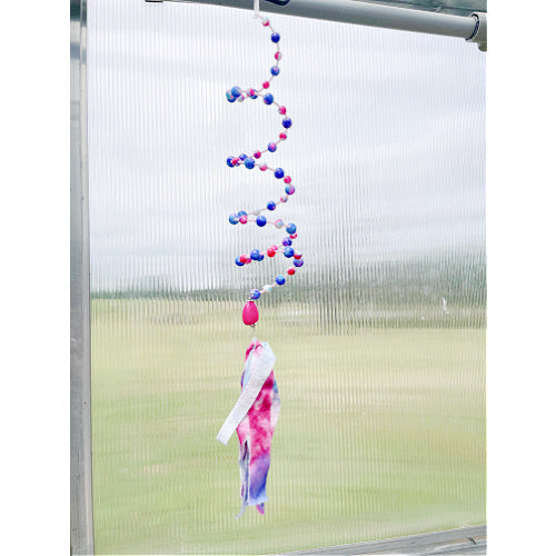 Playful Whimsy: A Pink and Purple Beaded Slinky Window Hanging