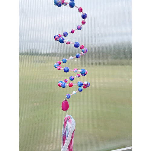 Playful Whimsy: A Pink and Purple Beaded Slinky Window Hanging