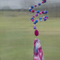 Playful Whimsy: A Pink and Purple Beaded Slinky Window Hanging